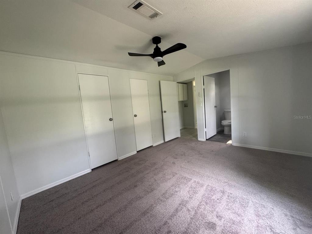 9053 Bourbon Street New Port Richey, FL 34654 - Photo 14 of 27 an empty room with a ceiling fan and window