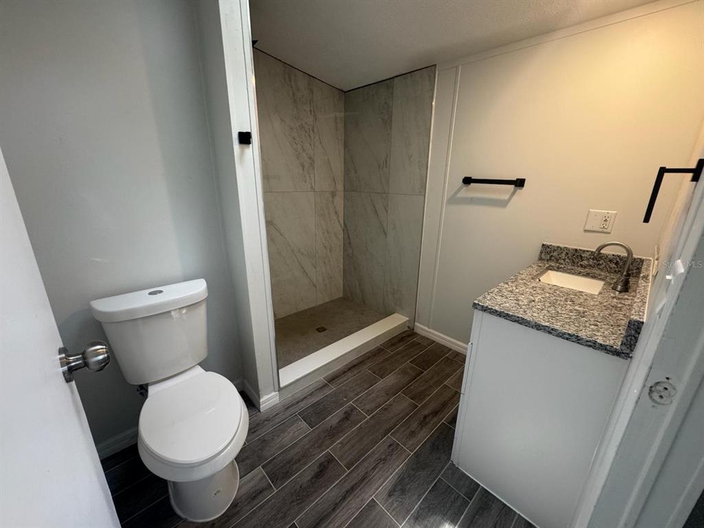 9053 Bourbon Street New Port Richey, FL 34654 - Photo 16 of 27 a white toilet sitting next to a bathroom sink