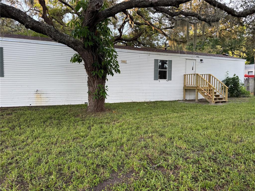 9053 Bourbon Street New Port Richey, FL 34654 - Photo 4 of 27 a white house that has tree in front of it