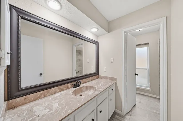 a bathroom with a sink and a mirror