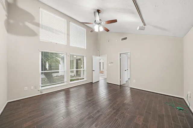 wooden floor in an empty room with a window
