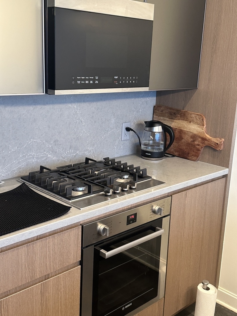 164 North Peoria Street, Unit 2801 Chicago, IL 60607 - Photo 6 of 16 a stove top oven sitting inside of a kitchen
