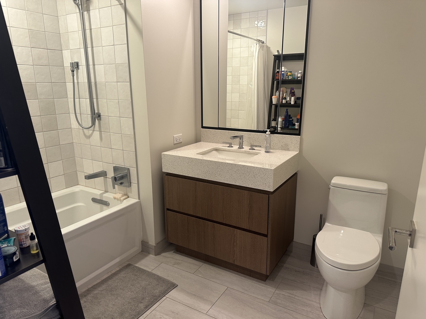 164 North Peoria Street, Unit 2801 Chicago, IL 60607 - Photo 8 of 16 a bathroom with a sink a toilet and a mirror