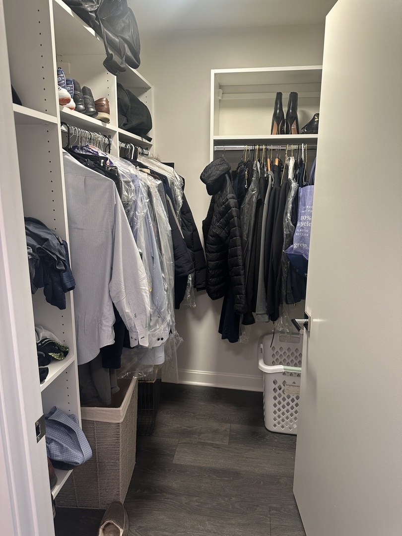 164 North Peoria Street, Unit 2801 Chicago, IL 60607 - Photo 9 of 16 a view of walk in closet with clothes and shoes