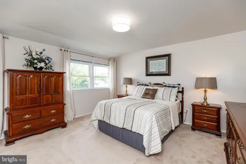 a spacious bedroom with a bed and a window