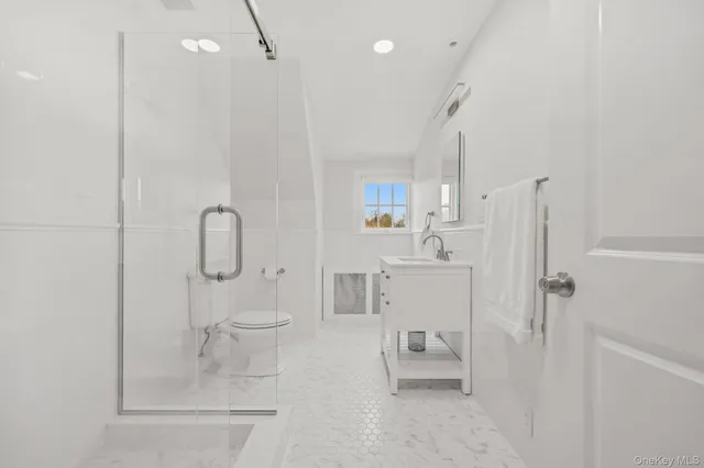 a bathroom with a shower toilet and sink