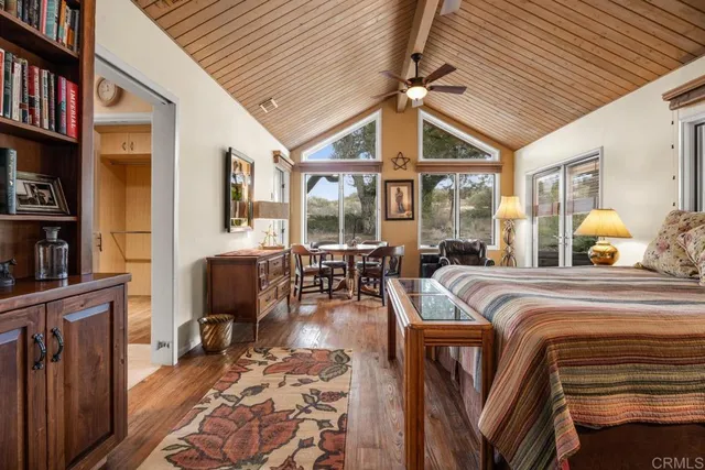 a spacious bedroom with a bed a bookshelf and a bookshelf
