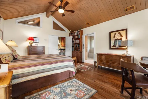 a bedroom with furniture and wooden floor