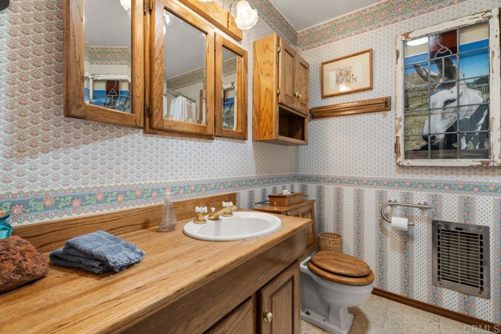 1088 Shasta Way Boulevard, CA 91905 - Photo 22 of 47 a bathroom with a sink a toilet and a mirror