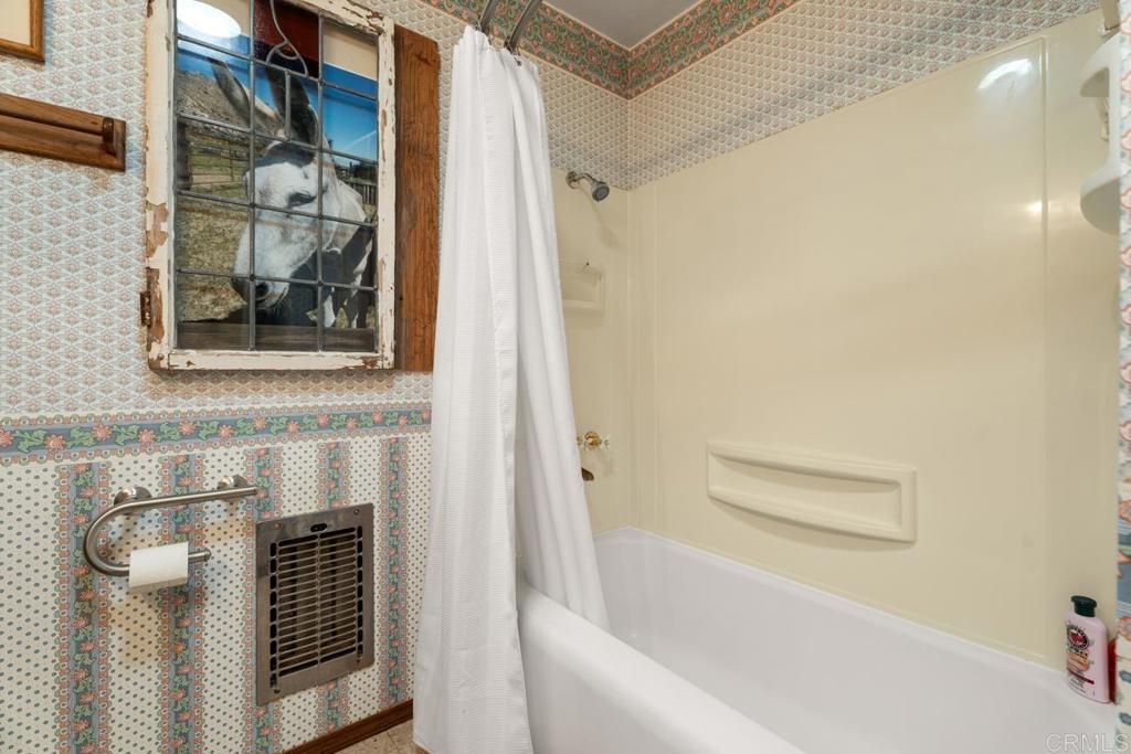 1088 Shasta Way Boulevard, CA 91905 - Photo 23 of 47 a bathroom with a bathtub and a shower