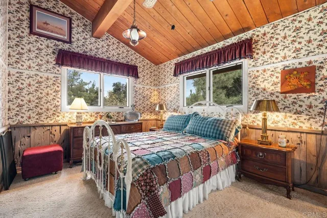 a bedroom with a bed a window and glass door