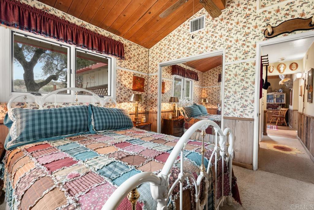 1088 Shasta Way Boulevard, CA 91905 - Photo 25 of 47 a bedroom with a bed a window and glass door