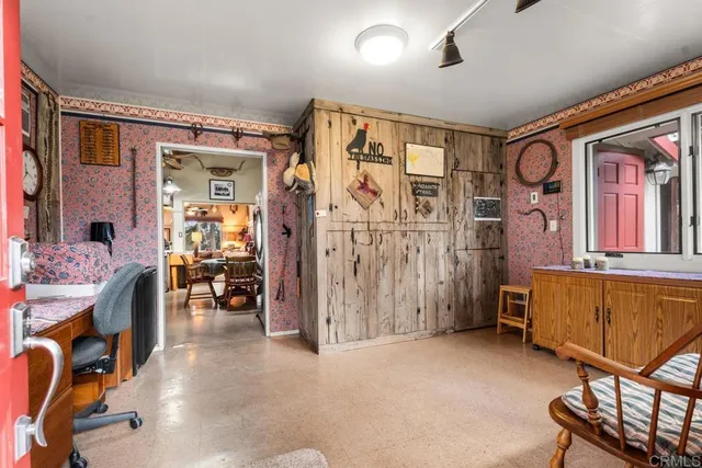 a bedroom with furniture and a large window