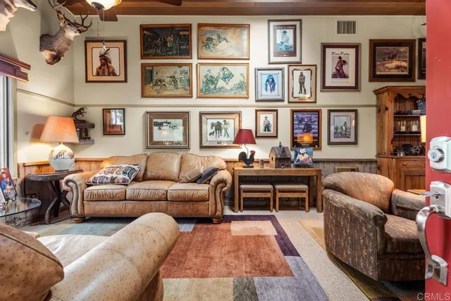 a living room with furniture fireplace and cabinets