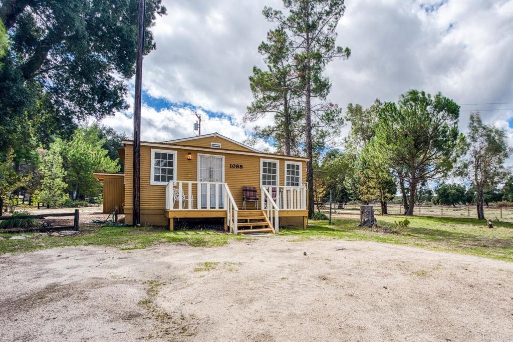 1088 Shasta Way Boulevard, CA 91905 - Photo 36 of 47 a view of a house with a yard and sitting area