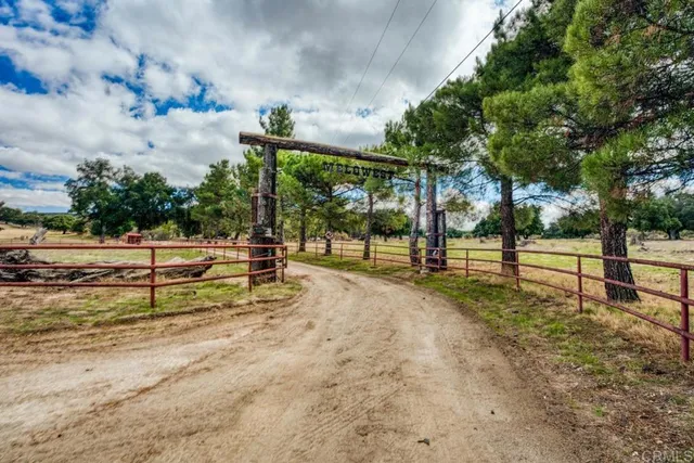 a view of a park with iron fence