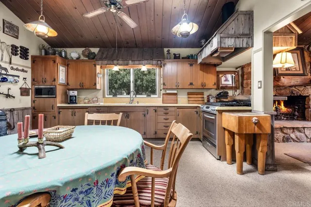 a kitchen with stainless steel appliances granite countertop a stove a sink and a dining table