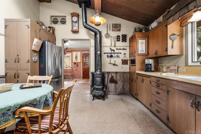 a kitchen with cabinets and chairs