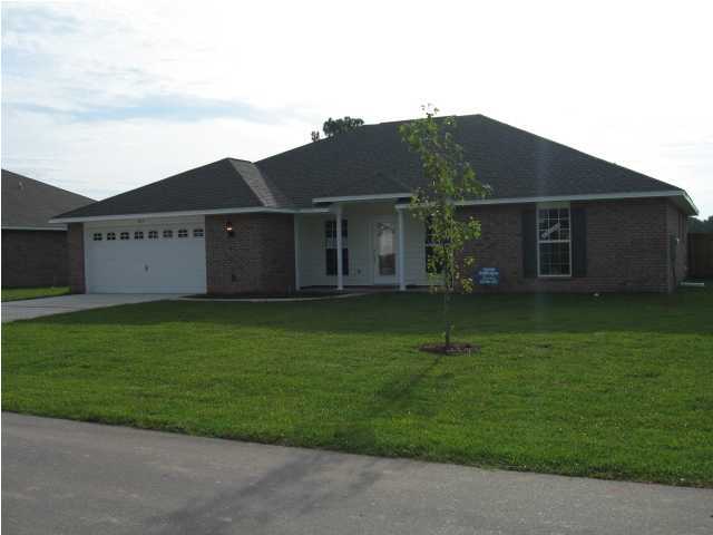 5219 Moore Loop Crestview, FL 32536 - Photo 1 of 14 a front view of a house with a garden