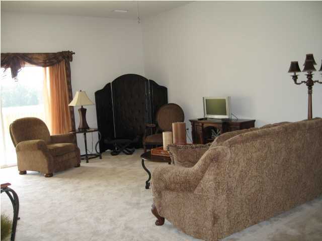 5219 Moore Loop Crestview, FL 32536 - Photo 11 of 14 a bed room with furniture and a fireplace