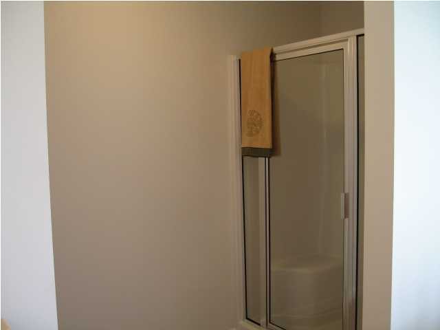 5219 Moore Loop Crestview, FL 32536 - Photo 4 of 14 a bathroom with a shower and a door