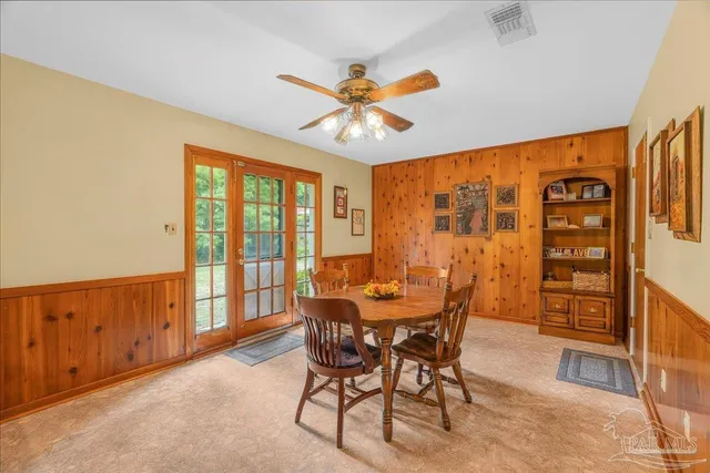 a dining room with furniture a chandelier and a rug