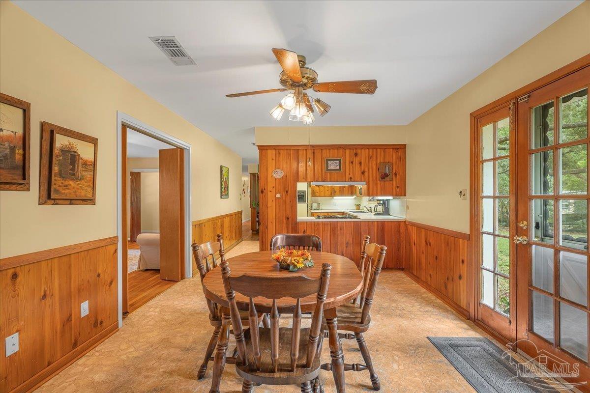 2021 Morningside Drive Pensacola, FL 32503 - Photo 15 of 44 a dining room with furniture a window and chandelier