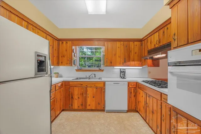a kitchen with stainless steel appliances granite countertop a sink and a stove