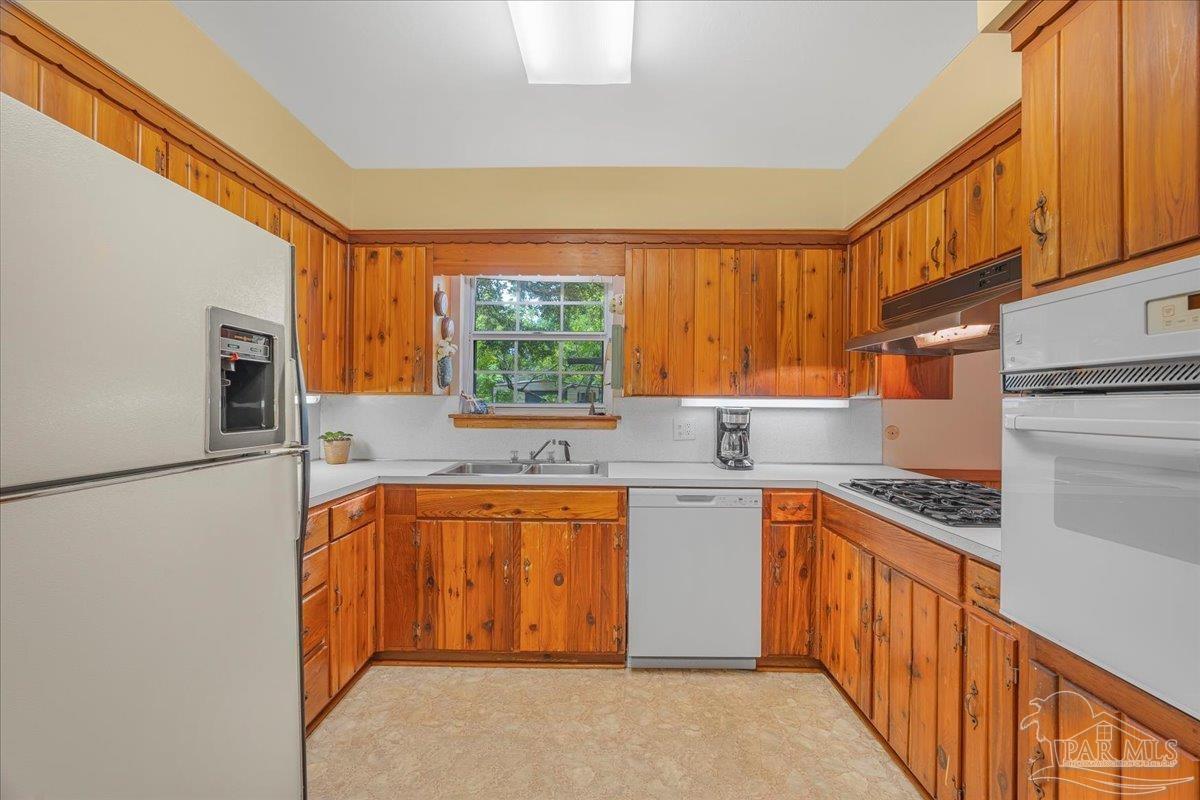 2021 Morningside Drive Pensacola, FL 32503 - Photo 17 of 44 a kitchen with stainless steel appliances granite countertop a sink and a stove