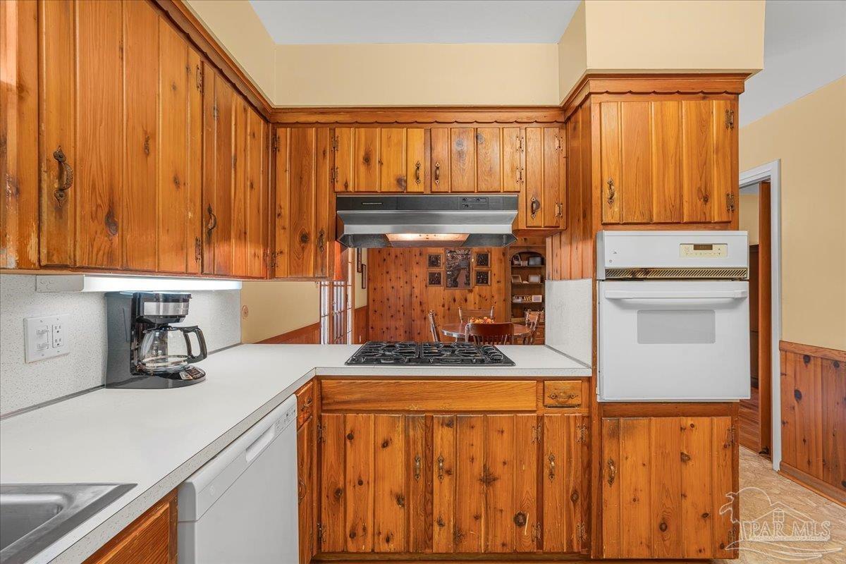 2021 Morningside Drive Pensacola, FL 32503 - Photo 18 of 44 a kitchen with stainless steel appliances a stove a sink and cabinets