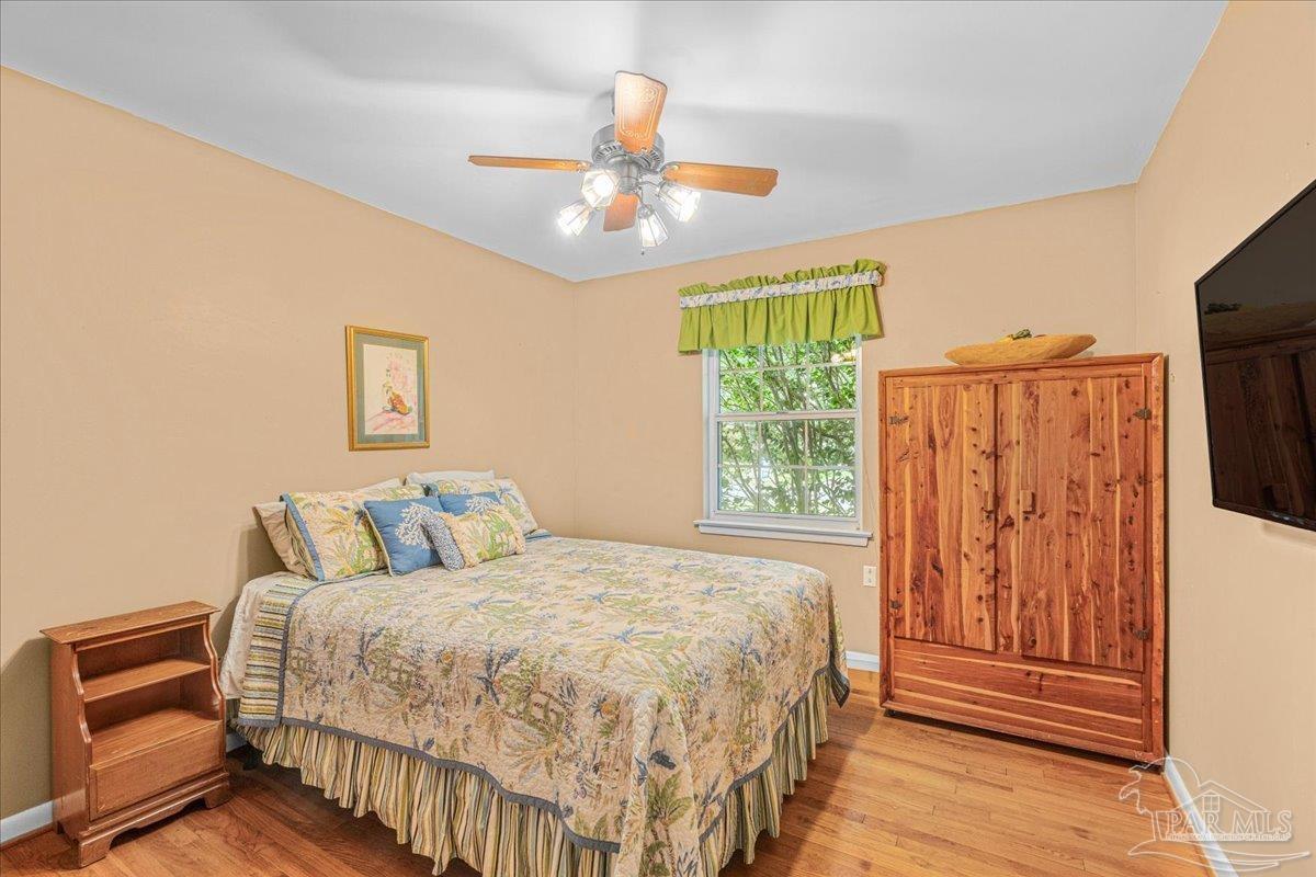 2021 Morningside Drive Pensacola, FL 32503 - Photo 27 of 44 a bedroom with a bed and wooden floor