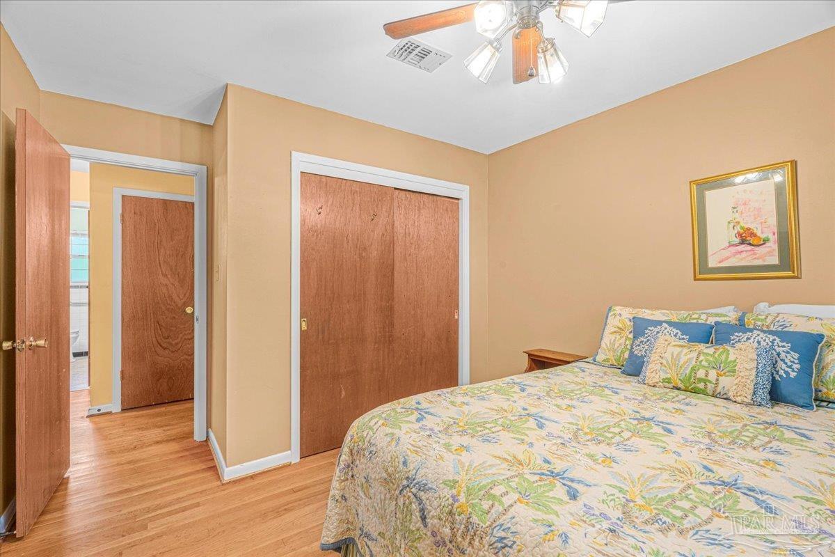 2021 Morningside Drive Pensacola, FL 32503 - Photo 28 of 44 a bedroom with a large bed and wooden floor