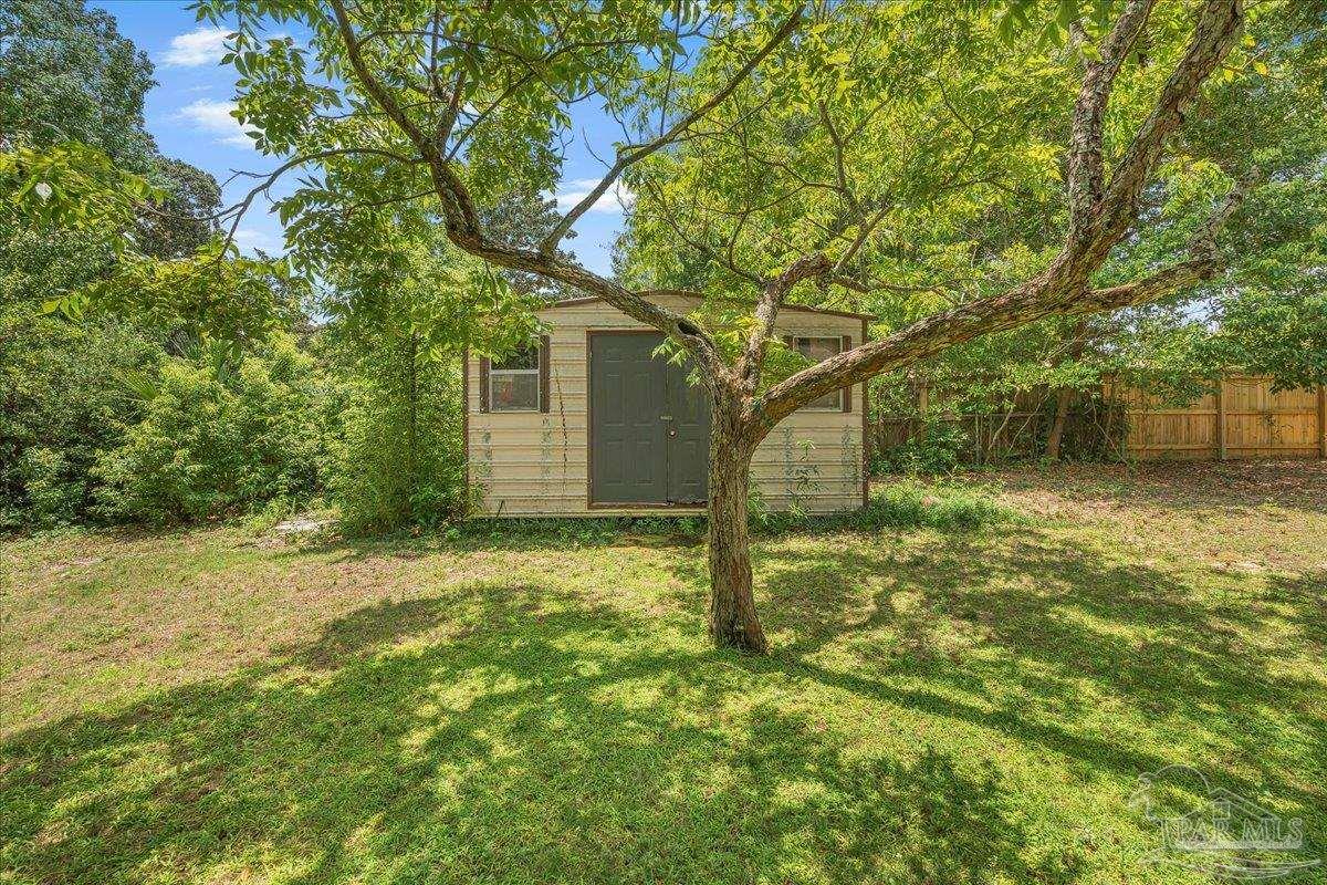 2021 Morningside Drive Pensacola, FL 32503 - Photo 38 of 44 a backyard of a house with lots of plants and large tree