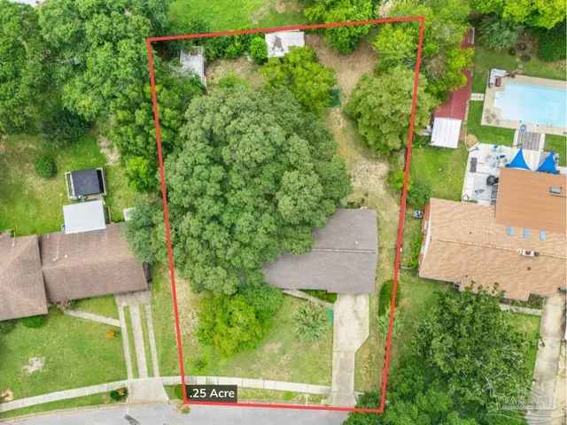 an aerial view of a house with a yard basket ball court and outdoor seating