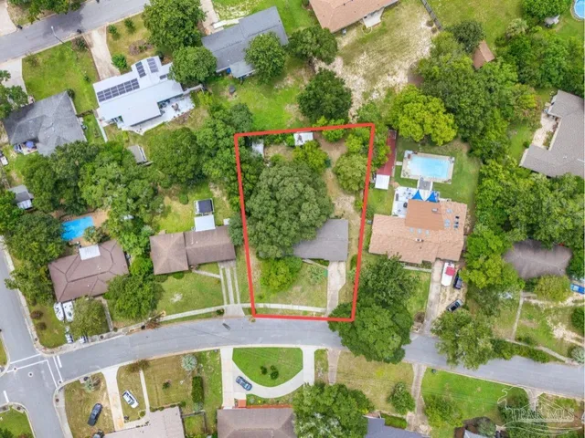 an aerial view of residential house with outdoor space and swimming pool