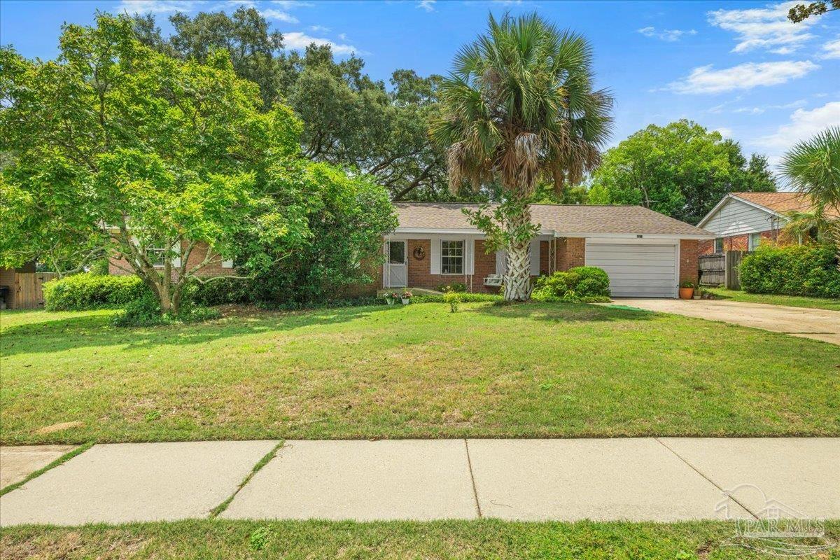 2021 Morningside Drive Pensacola, FL 32503 - Photo 7 of 44 a front view of a house with garden