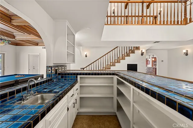 a kitchen with stainless steel appliances granite countertop a stove a sink dishwasher a dining table and chairs with wooden floor