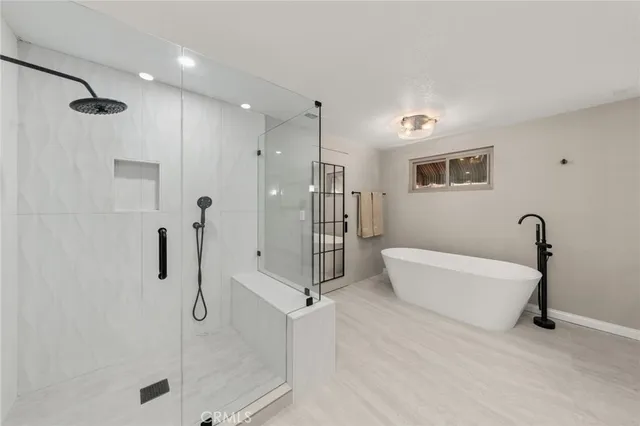 a bathroom with a bathtub and a shower
