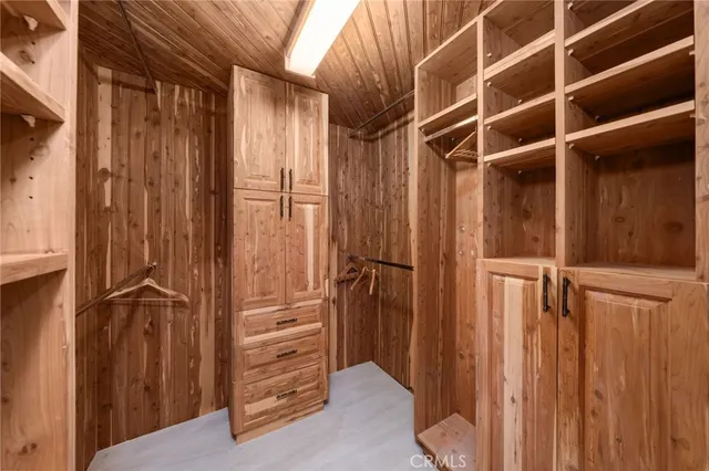 an empty room with a window and a ceiling fan