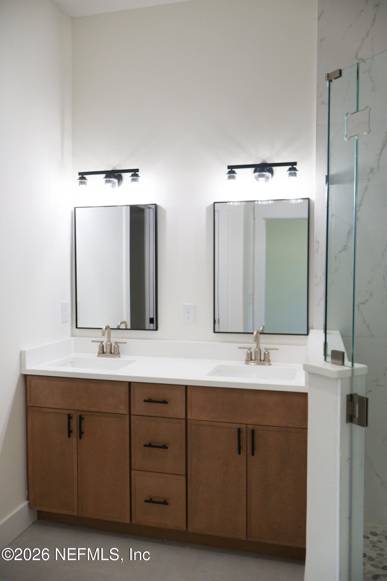 261121 Rowe Road Hilliard, FL 32046 - Photo 9 of 33 a bathroom with a double vanity sink and mirror