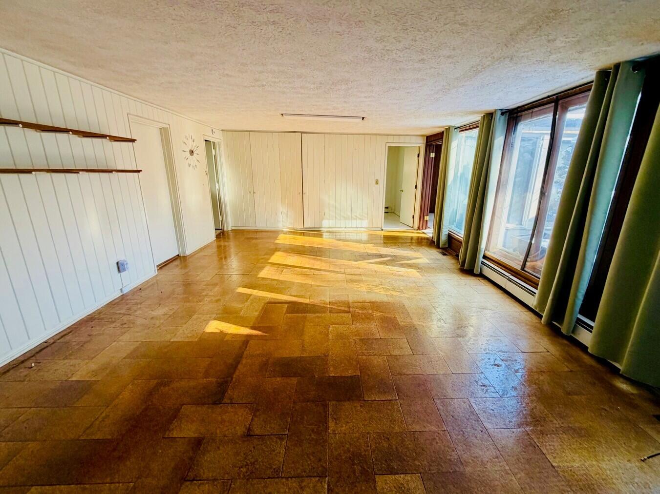 2401 Maple Street Michigan City, IN 46360 - Photo 7 of 12 a view of an empty room with wooden floor and a window