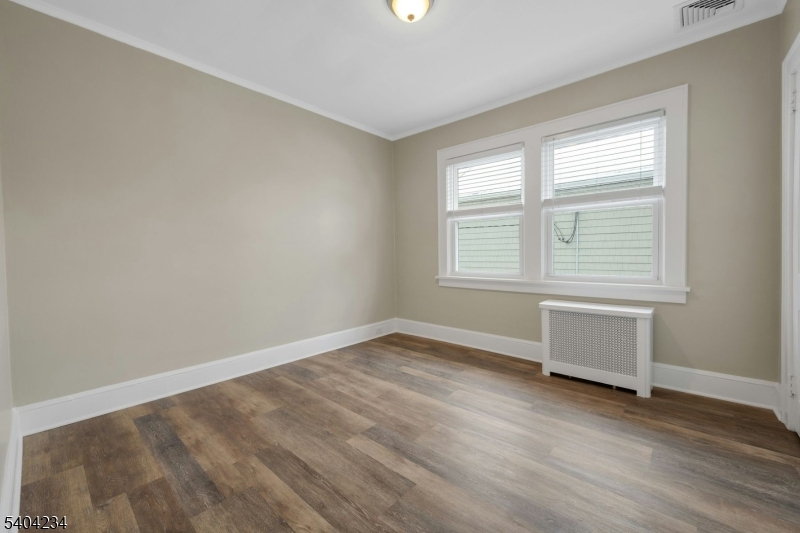 5 Gates Avenue Summit, NJ 07901 - Photo 13 of 24 an empty room with wooden floor and windows