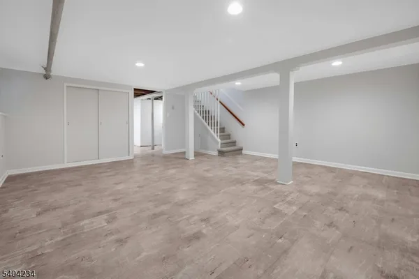 an empty room with staircase and white walls