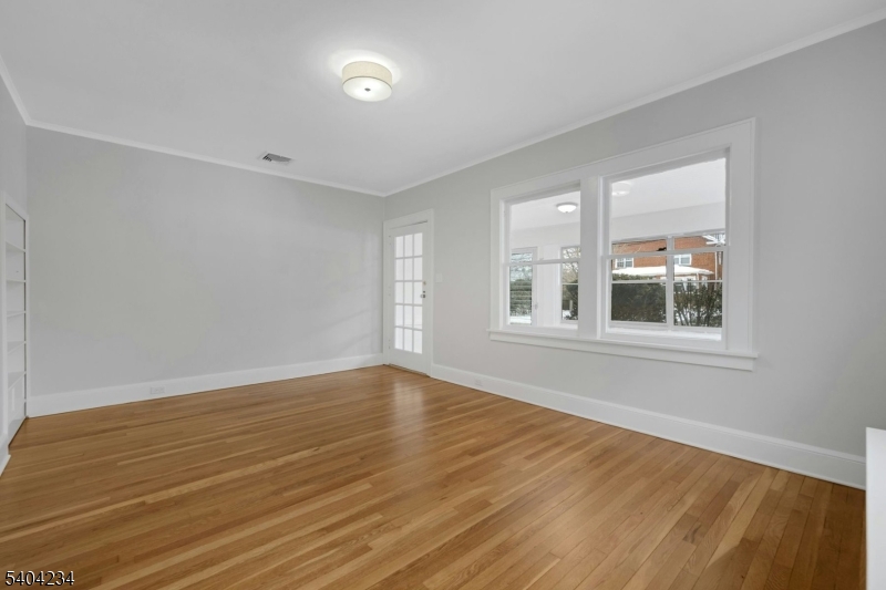 5 Gates Avenue Summit, NJ 07901 - Photo 3 of 24 a view of an empty room with wooden floor and a window