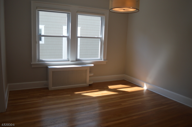 5 Gates Avenue Summit, NJ 07901 - Photo 5 of 14 a view of empty room with wooden floor and fan