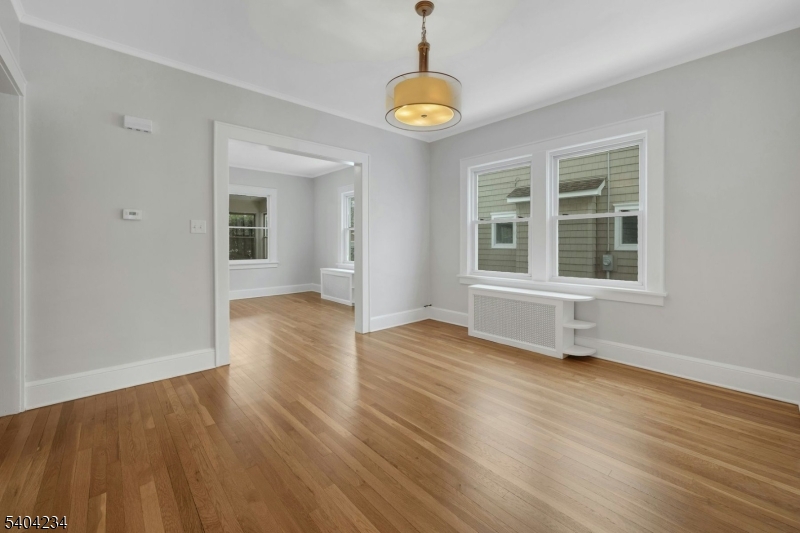 5 Gates Avenue Summit, NJ 07901 - Photo 5 of 24 a view of an empty room with wooden floor and a window
