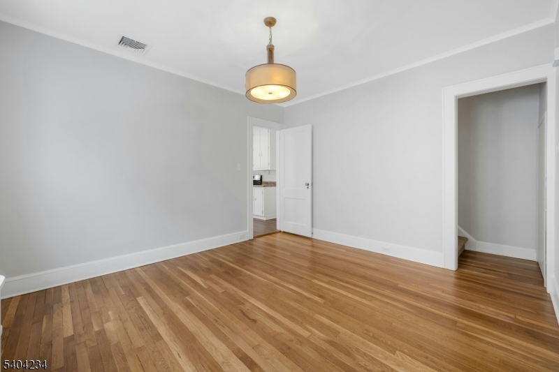 5 Gates Avenue Summit, NJ 07901 - Photo 6 of 24 a view of an empty room with wooden floor and a window