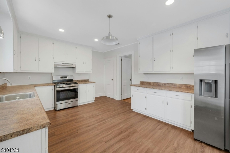 5 Gates Avenue Summit, NJ 07901 - Photo 7 of 24 a kitchen with granite countertop white cabinets and stainless steel appliances