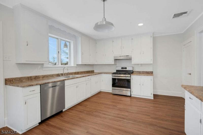 5 Gates Avenue Summit, NJ 07901 - Photo 9 of 24 a kitchen with granite countertop white cabinets and white appliances