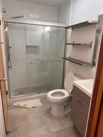 a bathroom with a toilet and a shower